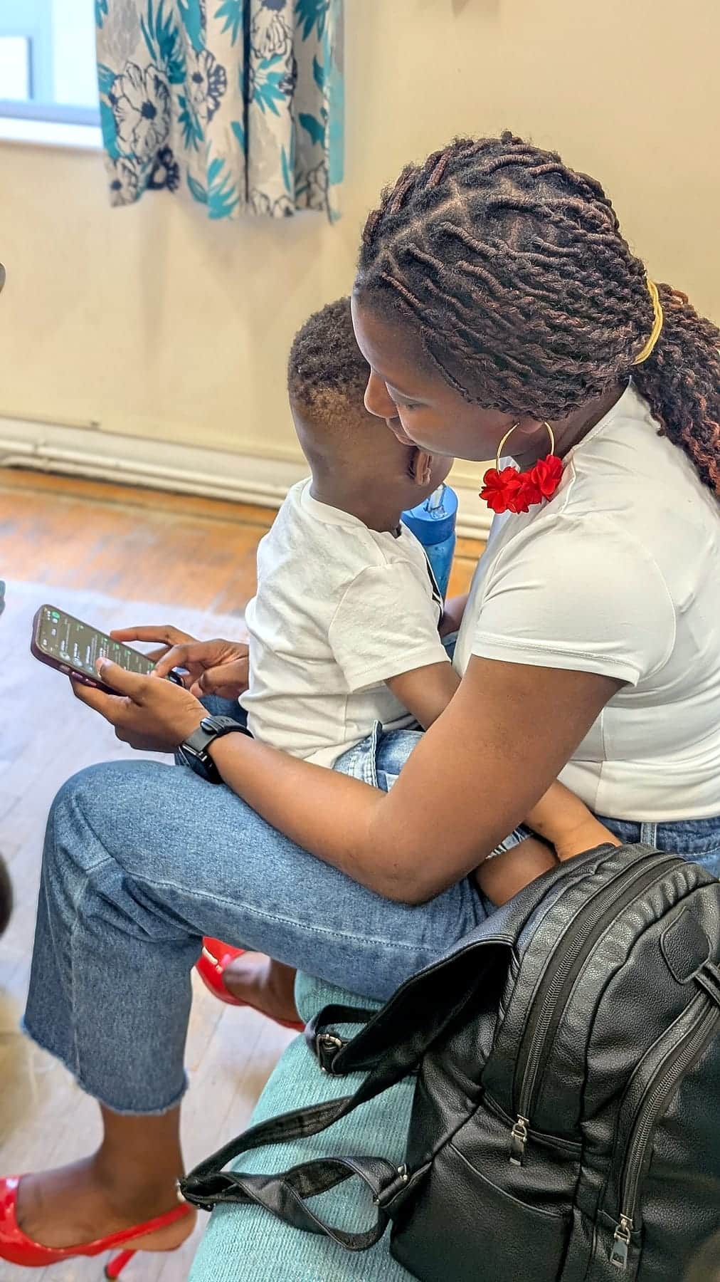 A mother holding her child during a gathering at BHCC