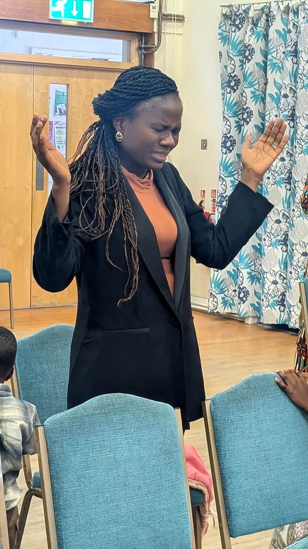 Hands raised in worship at a BHCC service